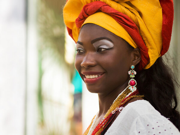 Salvador, Bahia, Brazil - October 13th, 2012: A Brazilian woman of African descent, smiling, wearing traditional clothes from the state of Bahia in the old colonial district of Salvador