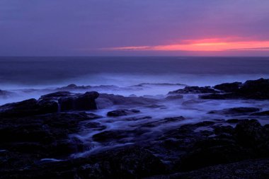 Velvet sunset or dusk on the rocky north coast of Portugal. Long exposure. ANALOG: 35mm. clipart