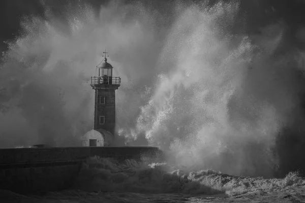 Big stormy wave splash. Used infrared filter. Douro mouth old granite south pier and lighthouse.