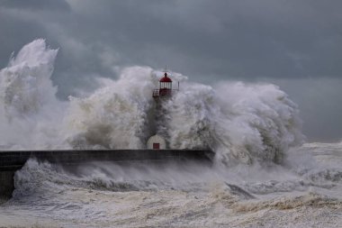 Storm at the Douro river mouth south old pier and lighthouse, Porto, Portugal.