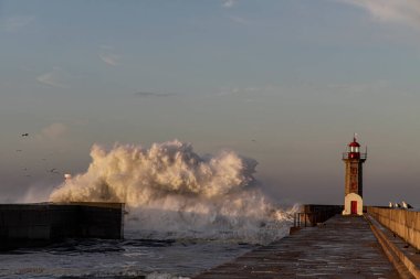 Big sea wave splash at dawn. Douro river mouth south piers.
