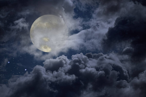 Cloudy full moon night with stars