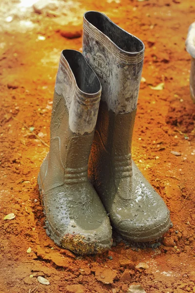 Shoes rubber boots on the ground. — Stock Photo, Image