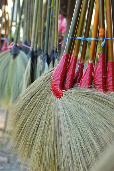 Brooms hanging for sale in the market. — Stock Photo, Image