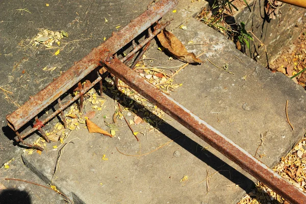 Steel rake on the cement floor. — Stock Photo, Image