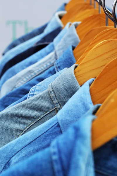 Shop shirts colorful fabric hanging on a rack. — Stock Photo, Image