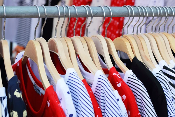 Shop shirts colorful fabric hanging on a rack. — Stock Photo, Image