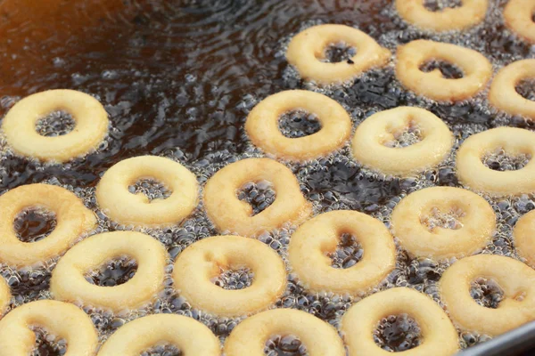 Making donut fried in a pan — Stock Photo, Image
