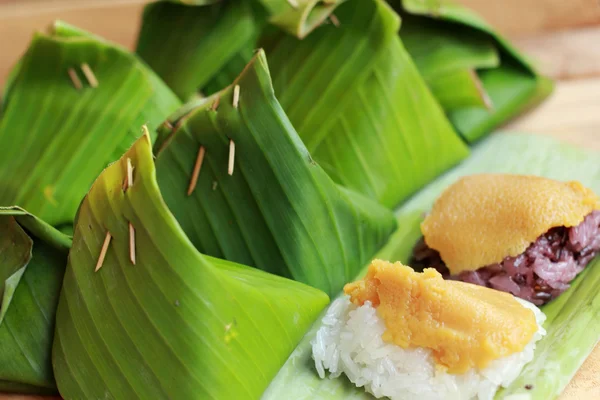 Sticky rice with custard wrapped in banana leaves. — Stock Photo, Image