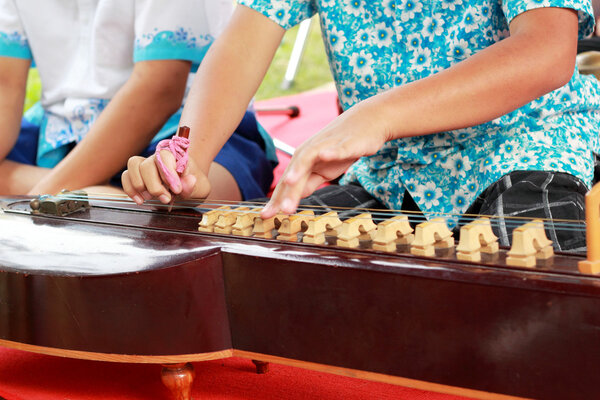 Children playing dulcimer Thailand