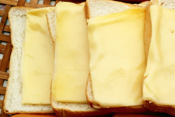 Cheese the place on a slice of bread. — Stock Photo, Image