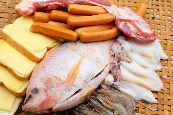 Fresh fish, squid, shrimp, streaky pork, sausages - for cooking. — Stock Photo, Image