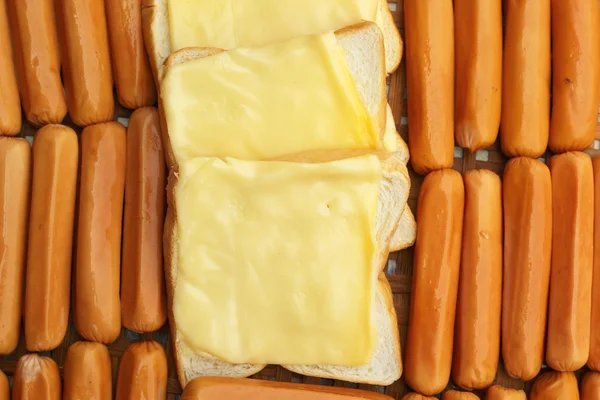 Cheese the place on a slice of bread and sausage. — Stock Photo, Image