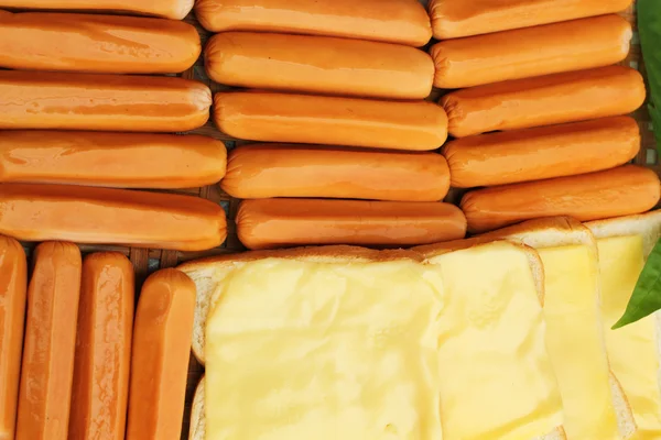 Cheese the place on a slice of bread and sausage. — Stock Photo, Image