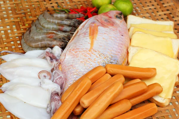 Fresh fish, squid, shrimp, streaky pork, sausages - for cooking. — Stock Photo, Image