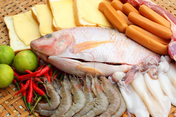 Fresh fish, squid, shrimp, streaky pork, sausages - for cooking. — Stock Photo, Image