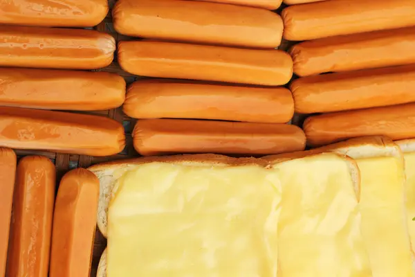 Cheese the place on a slice of bread and sausage. — Stock Photo, Image