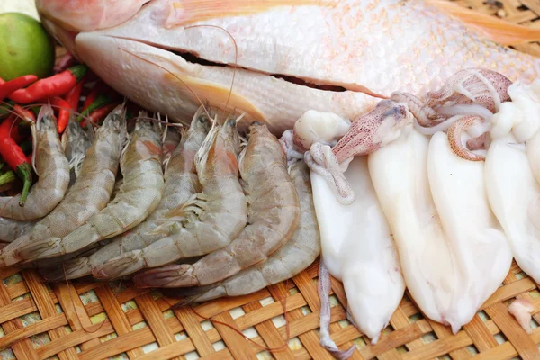 Fresh fish, squid, shrimp, streaky pork, sausages - for cooking. — Stock Photo, Image