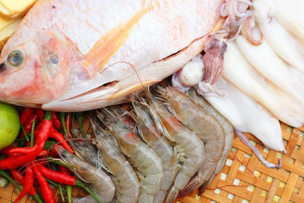 Fresh fish, squid, shrimp, streaky pork, sausages - for cooking. — Stock Photo, Image