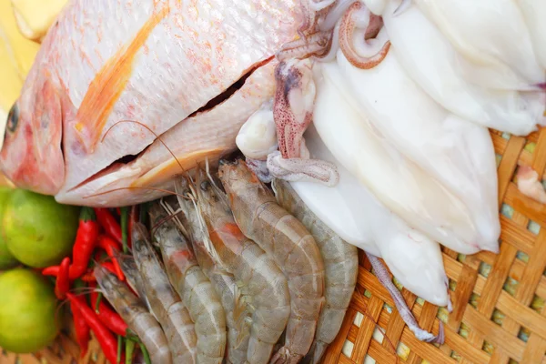 Fresh fish, squid, shrimp, streaky pork, sausages - for cooking. — Stock Photo, Image