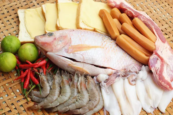 Fresh fish, squid, shrimp, streaky pork, sausages - for cooking. — Stock Photo, Image