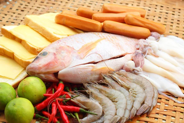 Fresh fish, squid, shrimp, streaky pork, sausages - for cooking. — Stock Photo, Image