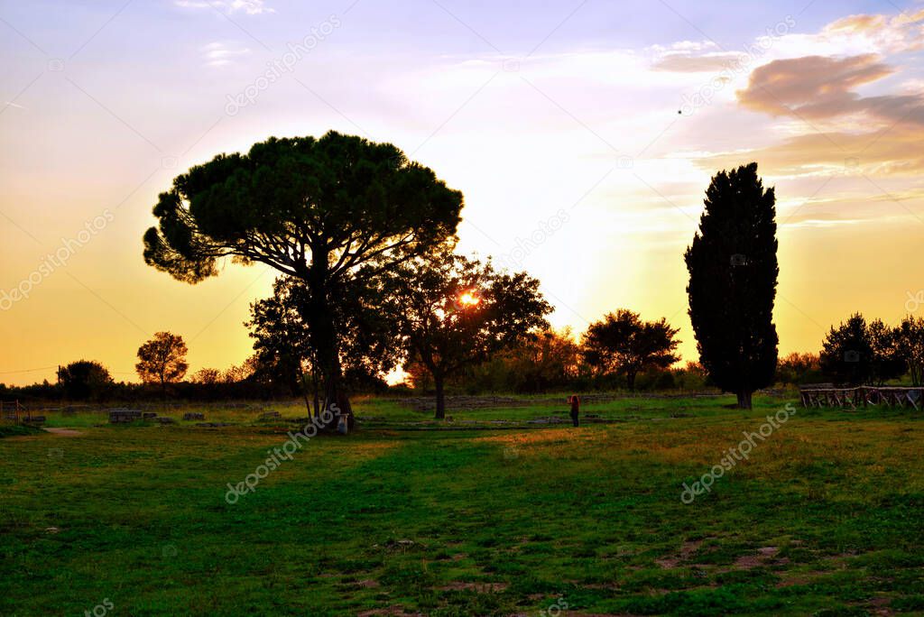 sunset in the valley of the ancient ruins of remains of religious buildings of the ancient Greek domination, capaccio paestum Italy