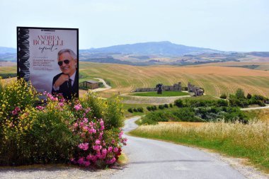 advertising poster announces the concert by Andrea Bocelli and the theater of silence built using the natural conformation of a hill 4 June 2022 Lajatico Italy