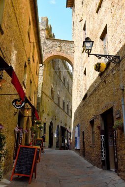 typical restaurants with outdoor tables in the alleys of the historic center of the Tuscan village 5 June 2022 Volterra  Italy