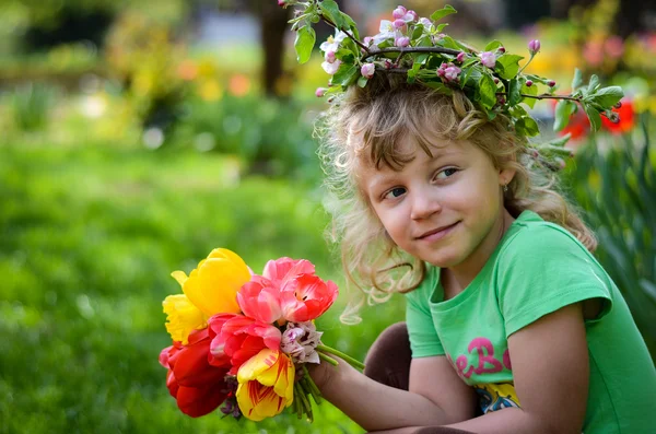 Child with tulips — Stock Photo, Image