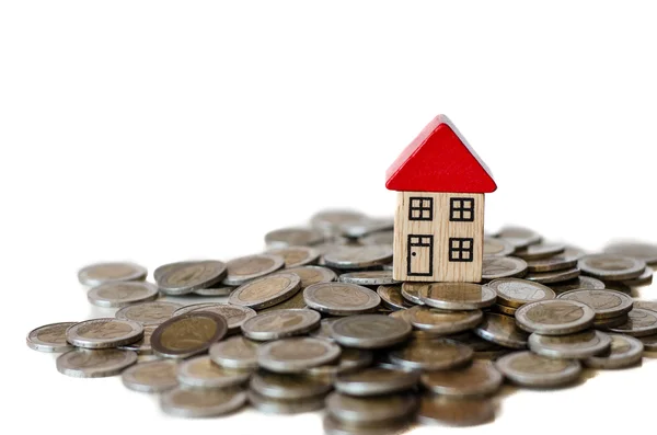 Coins and house standing on it — Stock Photo, Image