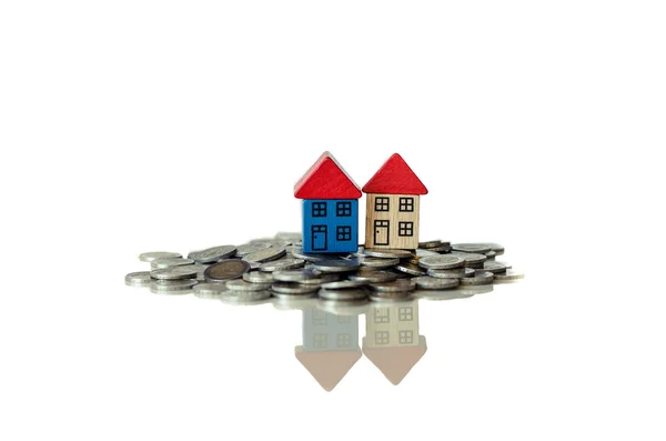 Coins and houses standing on it — Stock Photo, Image
