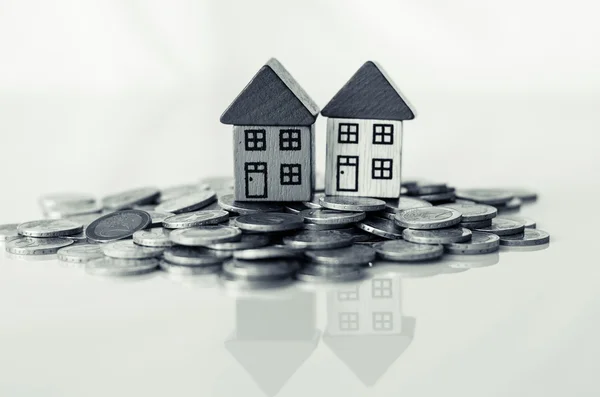 Coins and houses standing on it — Stock Photo, Image