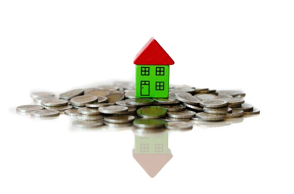 Coins and house standing on it — Stock Photo, Image