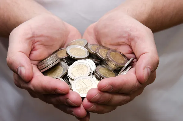 Coins in hands — Stock Photo, Image