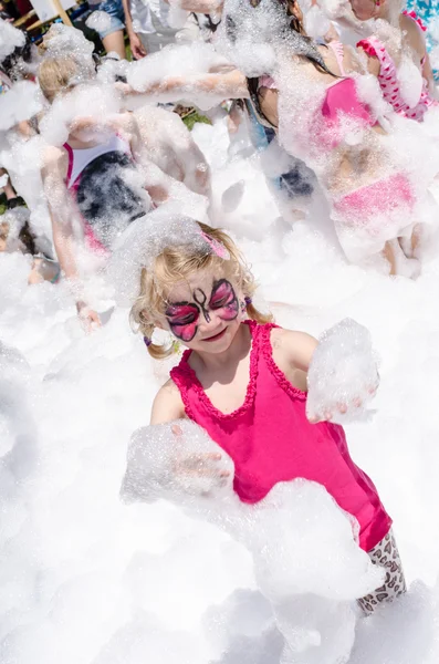 Child with face painting and foam party — Stock Photo, Image