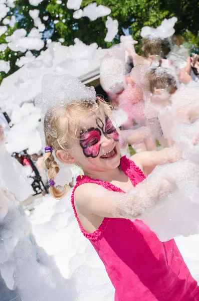 Niño con pintura facial y fiesta de espuma — Foto de Stock