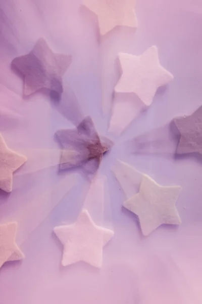 green and white stars blurred effect on purple backgrounds