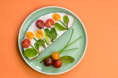 tereyağlı ekmek, kırmızı ve portakallı domates yeşil soğanlı ve fesleğenli çiçekler olarak tasarlandı