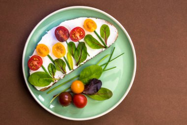 tereyağlı ekmek, kırmızı ve portakallı domates yeşil soğanlı ve fesleğenli çiçekler olarak tasarlandı