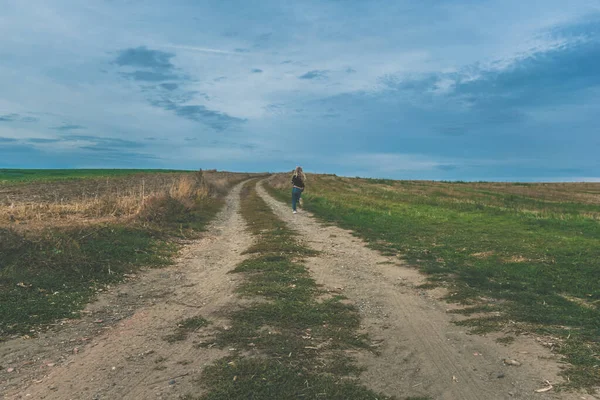 person leaving alone in lonely fields
