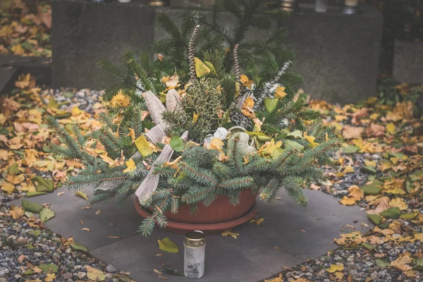 festive floral decoration on grave in the cemetery