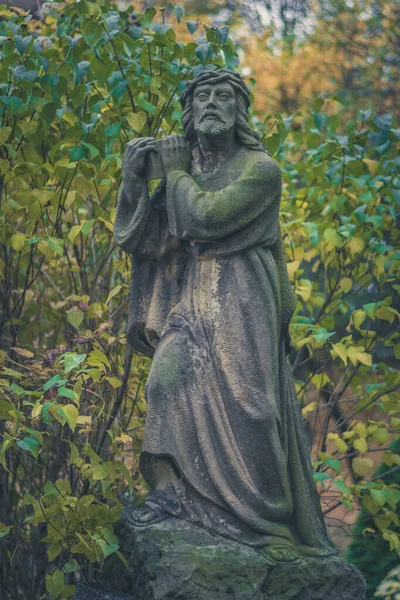 rocky statue of saint in the cemetery