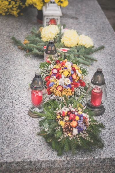 坟场的坟墓上点着蜡烛和菊花装饰 — 图库照片