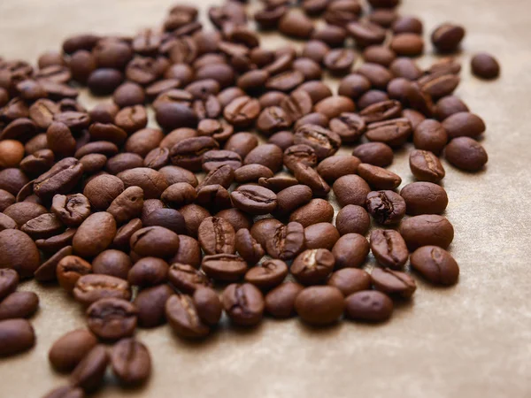 Photo of coffee beans on gold background — Stock Photo, Image