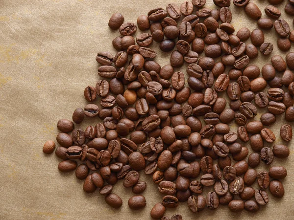 Photo of coffee beans on gold background — Stock Photo, Image