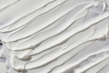 Beyaz yüz losyonu kusursuz bir arka plan. Cilt bakım dokusu.