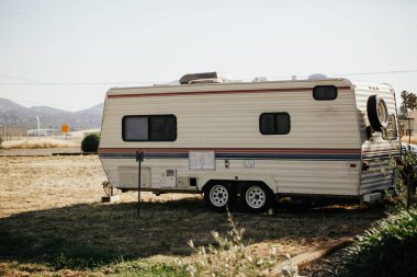 Old trailer parked on camping grounds,