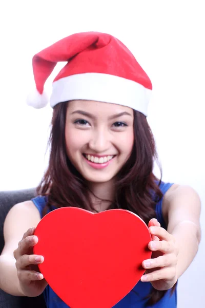 Asian woman with a christmas hat and carrying a chocolate box — Stock Photo, Image