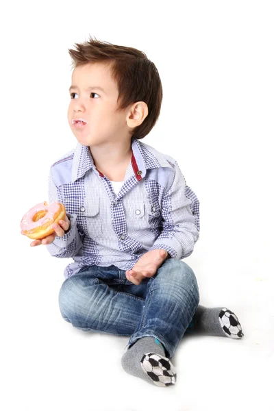 Boy eating dough nut — Stock Photo, Image